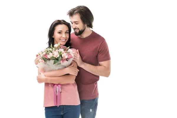 Retrato de mujer sonriente con ramo de flores y marido aislado en blanco - foto de stock