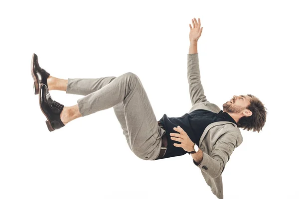 Assustado jovem empresário em terno caindo isolado no branco — Fotografia de Stock