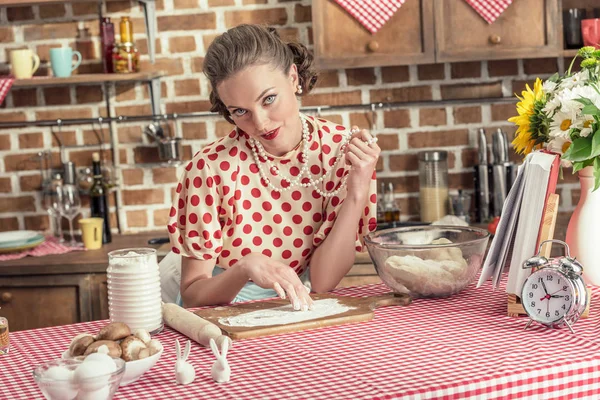 Smiling adult housewife with flour cooking and looking at camera at kitchen — Stock Photo