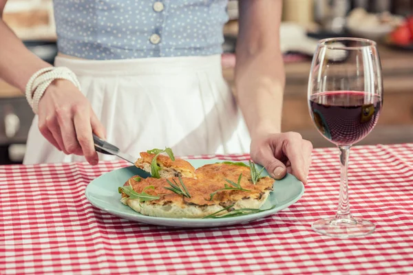 Cropped shot of housewife serving freshly baked mushroom cake at kitchen — Stock Photo