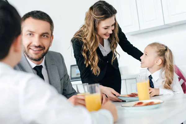 Family having breakfast in kitchen at home on first school day — Stock Photo