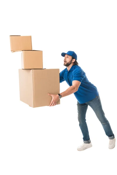 Delivery man holding stack of cardboard boxes isolated on white — Stock Photo