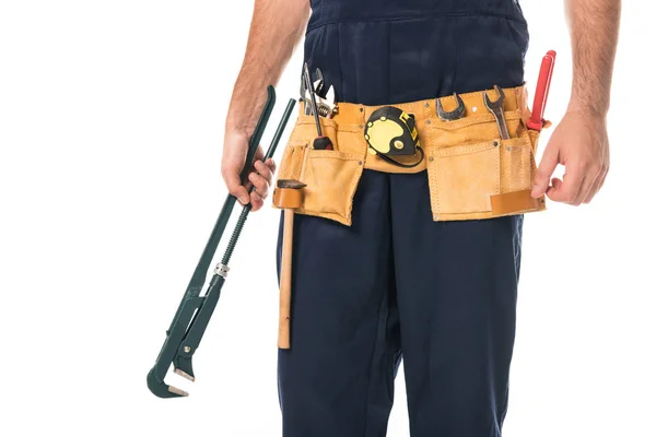 Cropped shot of repairman in tool belt holding adjustable wrench isolated on white — Stock Photo