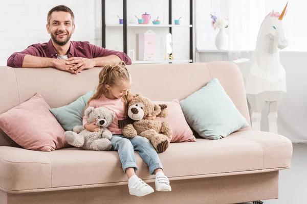 Father and daughter having fun on sofa — Stock Photo