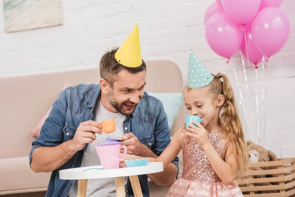 Father and daughter playing tea party at home — Stock Photo