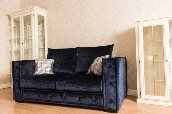 Interior of living room with blue sofa and wooden shelves — Stock Photo