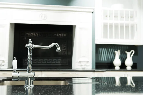 Part of modern kitchen in baroque style with tap and sink — Stock Photo