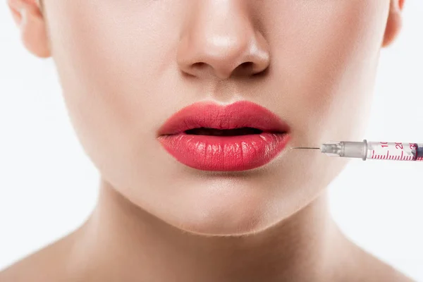 Close up of woman making beauty injection in lips, isolated on white — Stock Photo