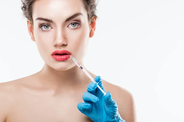 Woman making beauty injection in lips with syringe, isolated on white — Stock Photo