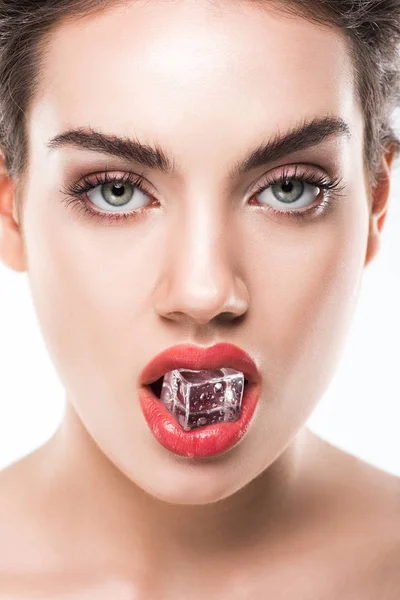 Attractive young woman holding ice cube in red lips, isolated on white — Stock Photo
