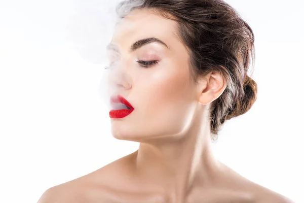 Hermosa mujer de moda soplando humo, aislado en blanco - foto de stock