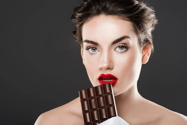 Stylish beautiful woman holding chocolate bar, isolated on grey — Stock Photo