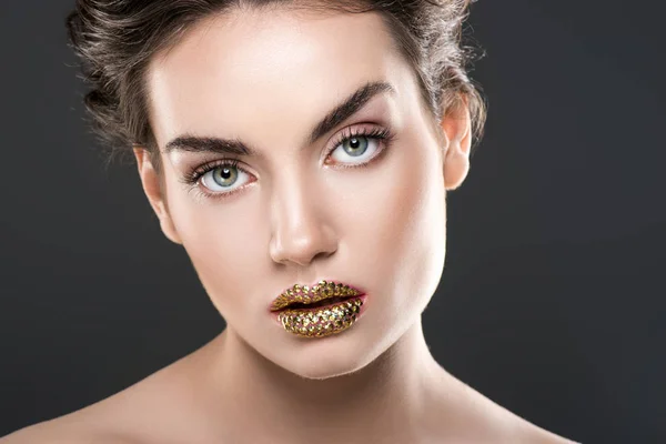 Schöne Frau mit goldenen Lippen, isoliert auf grau — Stockfoto