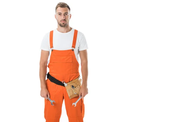 Handsome auto mechanic in orange uniform holding wrenches isolated on white — Stock Photo