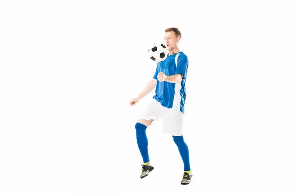 Full length view of athletic young soccer player training with ball isolated on white — Stock Photo