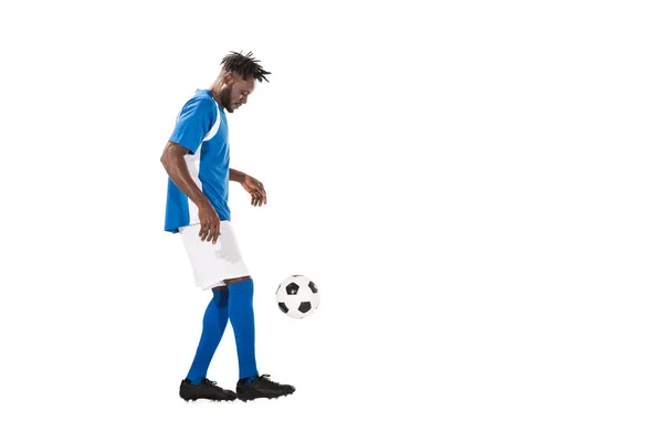 Athletic african american sportsman playing with soccer ball isolated on white — Stock Photo