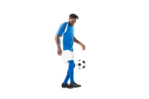 Side view of african american sportsman playing with soccer ball isolated on white — Stock Photo