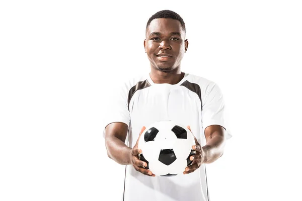 Schöner glücklicher junger afrikanisch-amerikanischer Sportler, der einen Fußballball in der Hand hält und isoliert auf weiß in die Kamera lächelt — Stockfoto