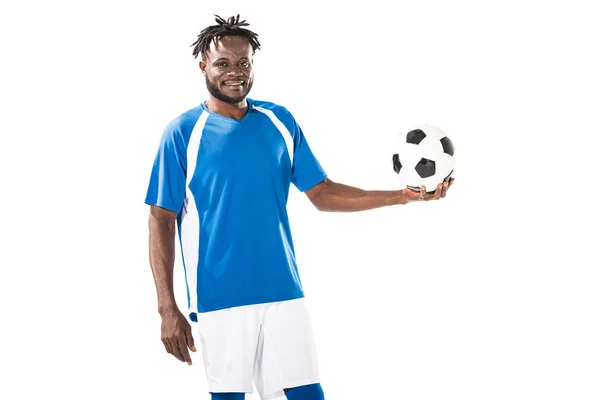 Happy african american sportsman holding soccer ball and smiling at camera isolated on white — Stock Photo