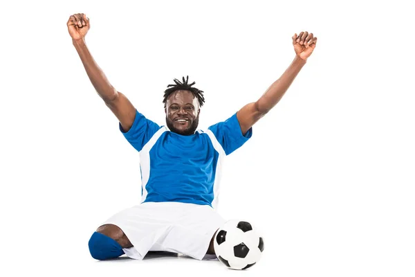 Emocionado jugador de fútbol afroamericano triunfando y sonriendo a la cámara aislado en blanco - foto de stock