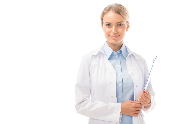 Smiling young female doctor with clipboard looking at camera isolated on white — Stock Photo