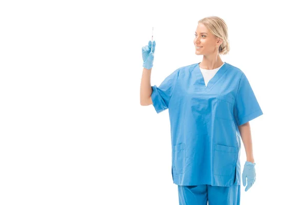 Attractive young nurse holding syringe for injection isolated on white — Stock Photo