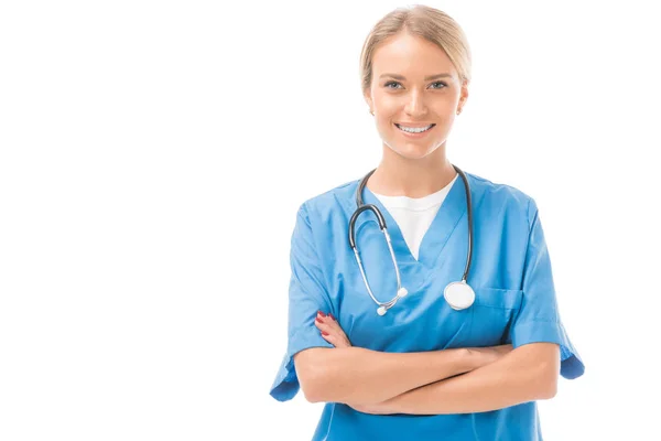 Happy young nurse with crossed arms looking at camera isolated on white — Stock Photo