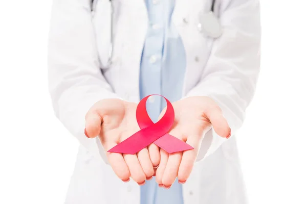 Cropped shot of female doctor holding aids awareness red ribbon symbol isolated on white — Stock Photo