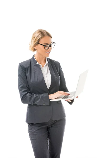 Attractive young businesswoman working with laptop isolated on white — Stock Photo