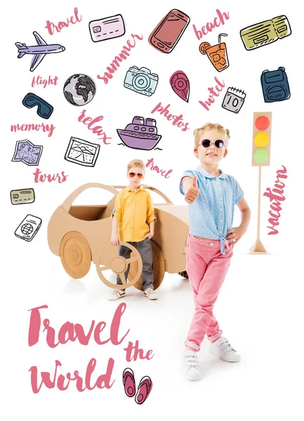 Stylish kid in sunglasses showing thumb up while boy standing near cardboard car and traffic lights, with trip icons and 