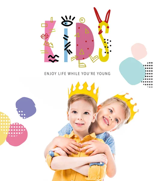 Sister hugging brother, kids in yellow paper crowns, isolated on white with 