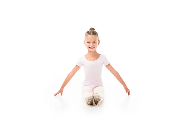Smiling little ballerina practicing isolated on white background — Stock Photo