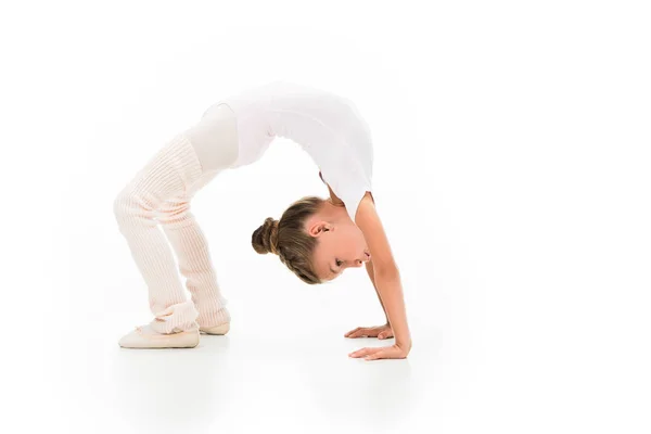 Side view of little kid performing gymnastics bridge isolated on white background — Stock Photo