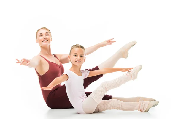 Animada entrenadora femenina y pequeña bailarina practicando aislada sobre fondo blanco - foto de stock