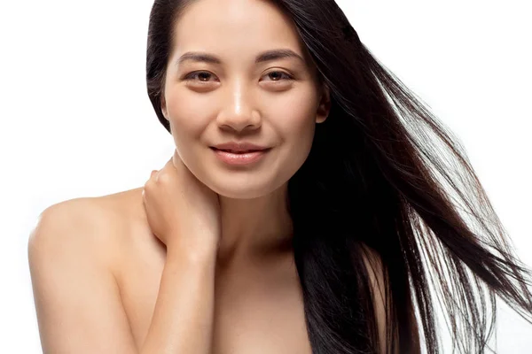 Portrait of smiling asian model with strong and healthy hair looking at camera isolated on white — Stock Photo