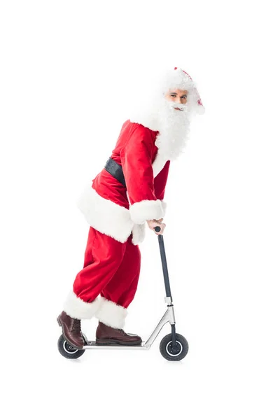 Happy santa claus in costume riding on kick scooter isolated on white background — Stock Photo