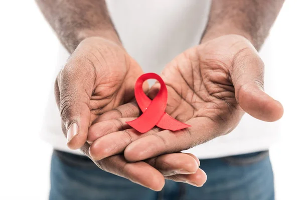 Cropped shot of african american man holding aids awareness red ribbon isolated on white — Stock Photo