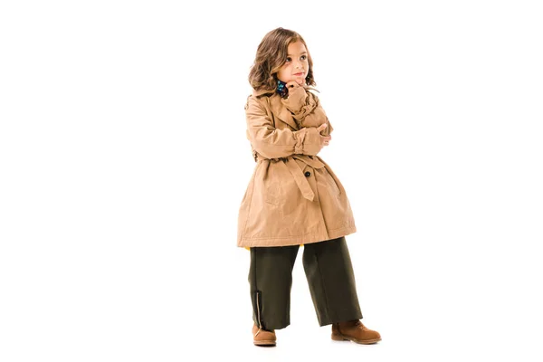 Thoughtful little child in trench coat isolated on white — Stock Photo