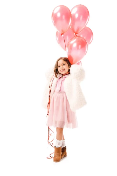 Criança pequena feliz em roupas elegantes com balões de ar rosa isolados em branco — Fotografia de Stock