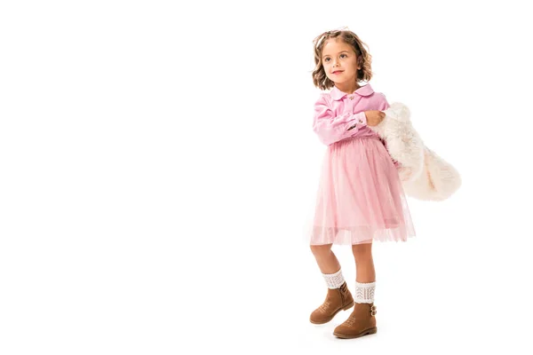 Adorable little child in pink clothes and white fur coat isolated on white — Stock Photo
