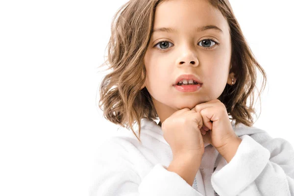 Portrait of adorable child in white bathrobe looking at camera isolated on white — Stock Photo