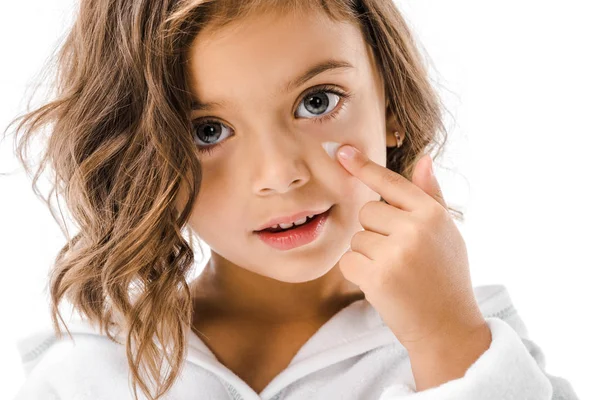 Portrait of little kid applying on facial cream isolated on white — Stock Photo