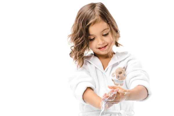 Portrait of little kid in bathrobe washing hands with soap isolated on white — Stock Photo