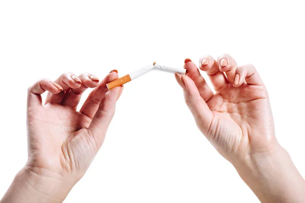 Cropped image of woman breaking unhealthy cigarette isolated on white — Stock Photo