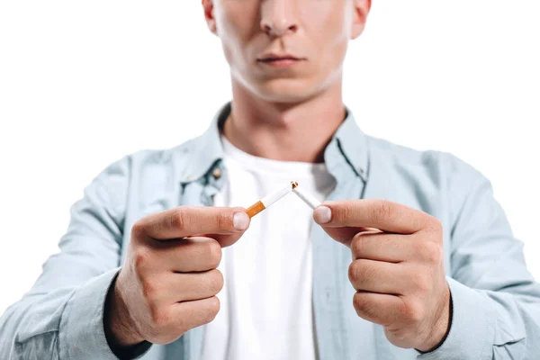 Cropped image of man in casual clothes breaking unhealthy cigarette isolated on white — Stock Photo