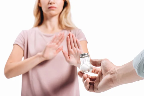 Cropped image of woman rejecting saltcellar with powdered salt isolated on white — Stock Photo