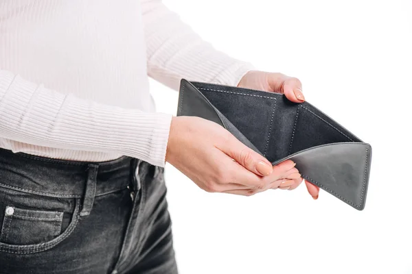 Cropped image of woman opening empty black purse isolated on white — Stock Photo