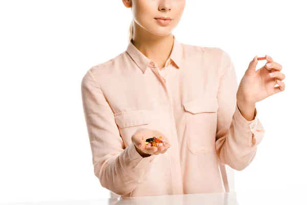 Cropped image of woman holding pills isolated on white — Stock Photo