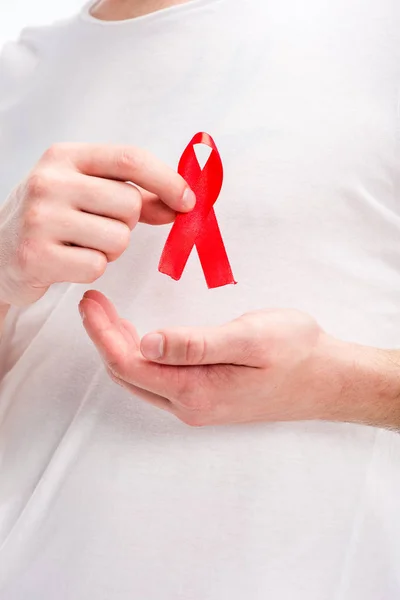 Cropped image of man holding red ribbon isolated on white, world aids day concept — Stock Photo