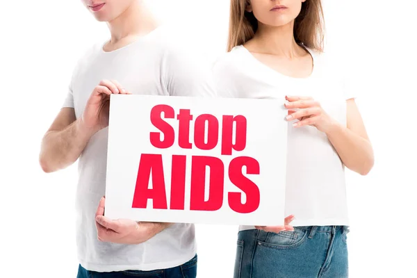 Cropped image of heterosexual couple holding card with stop aids text isolated on white, world aids day concept — Stock Photo